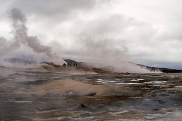 Volcanic terrain near crater with smoke