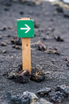 Green waymark sign in stony ground