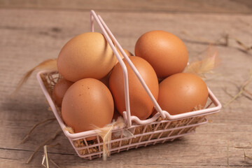 Fresh eggs in a basket on a wooden background.Copy space.