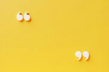 Fotobehang Quotation mark with copy space on yellow background, White quotation mark on yellow wall 3d illustration. © Washdog