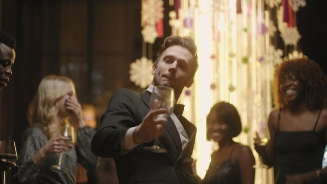 drunk man on New year corporate party, dancing and looking at camera, having fun in holidays