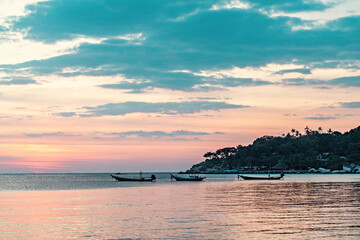 Fototapeta na wymiar Spectacular sunset with boats in the sea, Koh Tao, Thailand