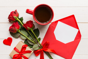 Valentine day composition with coffee cup, rose flower and gift box on table. Top view, flat lay. Holiday concept