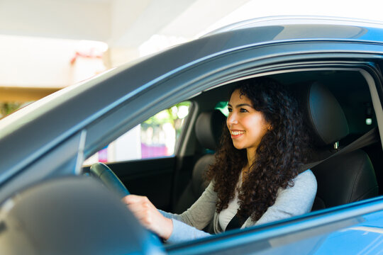 Attractive woman enoying driving her car