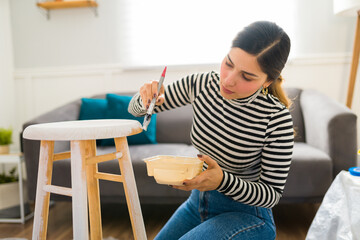Gorgeous woman doing DIY projects with furniture