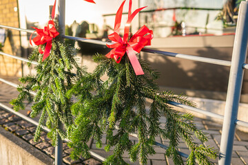 Christmas and New Year decoration outdoors, beautiful Christmas tree branches. Holiday festive atmosphere on a sunny day. 