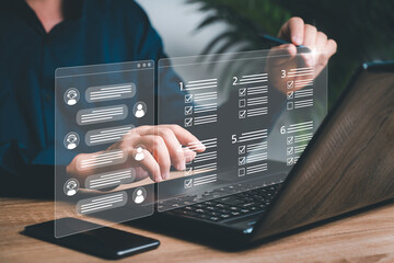 Online satisfaction survey from the automation concept, Businessman use smartphones and laptops mark online satisfaction surveys and mark detail on smart checklists to data store information