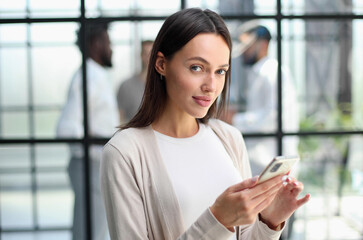 Businesswoman with phone in modern office