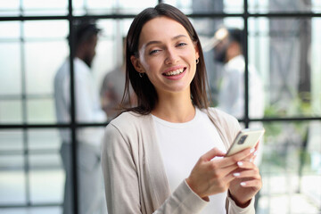 Businesswoman with phone in modern office