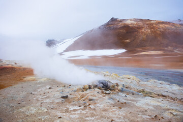Boiling mudpots in the geothermal area Hverir and cracked ground around. Location: geothermal area Hverir, Myvatn region, North part of Iceland, Europe