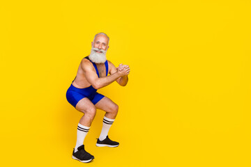 Fototapeta na wymiar Full length photo of funky funny retired man dressed blue overall costume sitting up empty space isolated yellow color background
