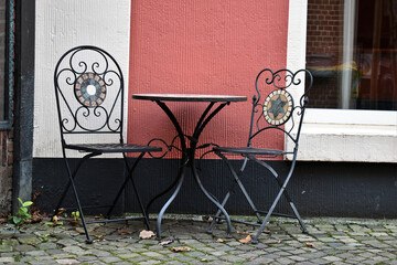 cafe tables and chairs in street, urban lifestyle in the cities of europe