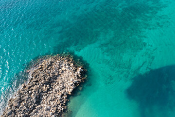 Rocks coast in the transperency Mediterranean sea top view