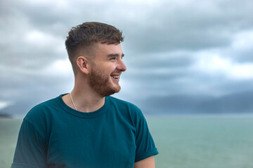 Profile side photo of handsome happy guy, young man enjoying sea, ocean view, landscape, looking...