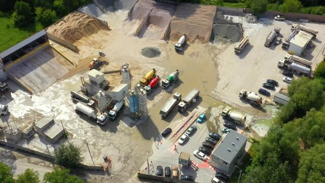 Construction sustainable building materials bulk facility concrete cement granulate materials. Aerial drone view. Conveyor plant silos