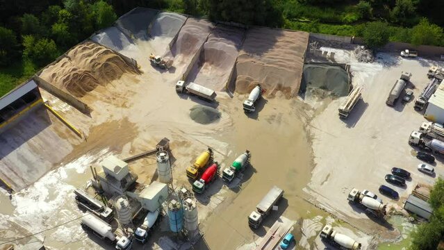 Construction sustainable building materials bulk facility concrete cement granulate materials. Aerial drone view. Conveyor plant silos