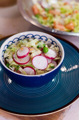 Salad of radish and cabbage with greens with peas, dill and sesame seeds.