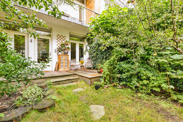 the back yard with trees and plants in the fore - image courtesy by real estate agents / real...
