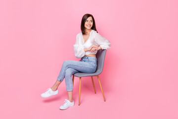 Full length photo of pretty cute lady sit chair look empty space banner poster advert wear trendy...