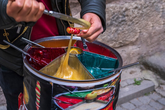 colorful sweet paste. Turkish street dessert. street vendor sells colorful sugar pastes for children. Selective Focus Yellow one.