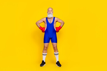 Fototapeta na wymiar Full length photo old age senior professional wear blue sportswear showing figure big muscles serious isolated on bright yellow color background