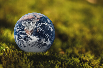 Together we can save the world and offer the better world for our children and Earth day concept, Butterfly and love heart shaped earth on glass, Elements of this image furnished by NASA