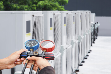 Technician checking the operation of the air conditioner.	