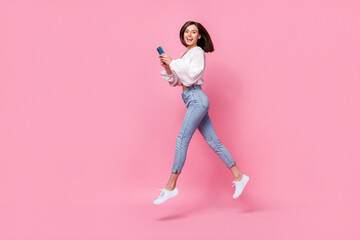 Full length photo of positive blogger lady hold device gadget facebook instagram telegram step empty space isolated pink color background