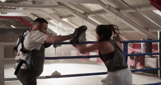 Female boxer practicing to evade opponent