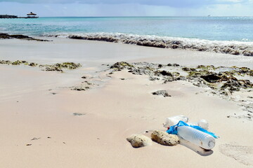 Fototapeta na wymiar Plastic in the ocean, pollution on the caribbean dream beach