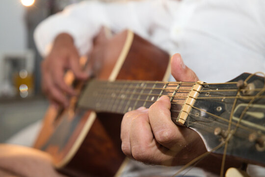 Person Playing Guitar