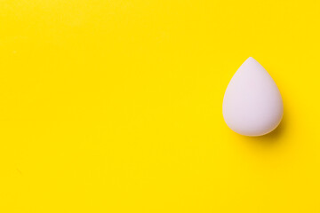 Beauty blender on color background, top view
