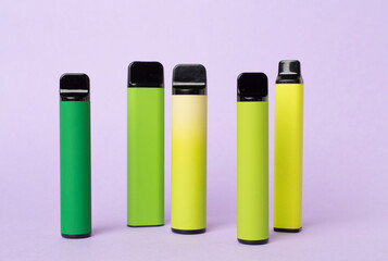 Disposable electronic cigarettes on color background