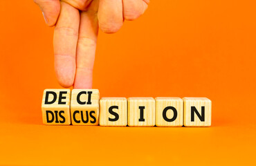 Discussion and decision symbol. Concept word Discussion and Decision on wooden cubes. Businessman hand. Beautiful orange table orange background. Business discussion and decision concept. Copy space.