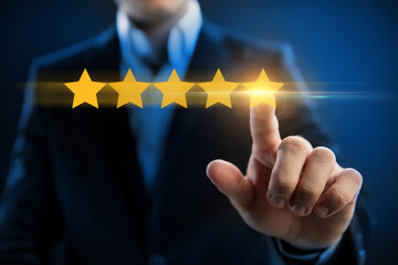 Businessman pointing five star symbol to increase rating of company. Evaluation of online services....