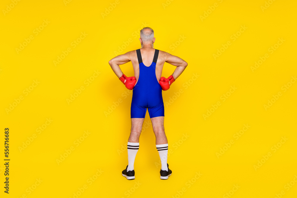 Sticker Full length photo old age pensioner wear blue costume showing behind arms waist good figure muscles red boxing gloves isolated on yellow color background