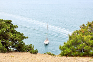 A snow-white yacht stands in the bay on a clear sunny day