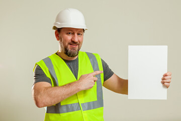 worker in a vest and white helmet