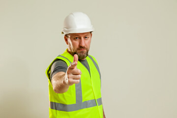 worker in a vest and white helmet