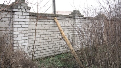 wood supports a brick fence