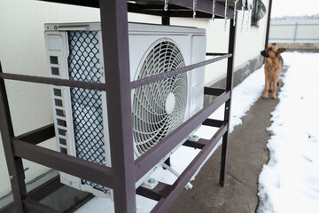 Air conditioner Outdoor Unit in Winter. The outdoor unit of the air conditioner (air-to-air heat pump) in the snow during winter operation.