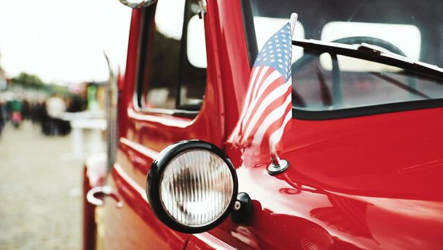 Close Side View Of Red Pickup Truck With Small American Flag Waving.