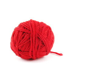 Red coiled ball of knitting thread with an open thread on a white background