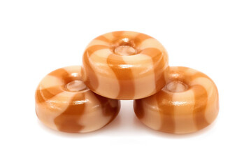 Milk caramel on a white background. Round caramel candy isolate