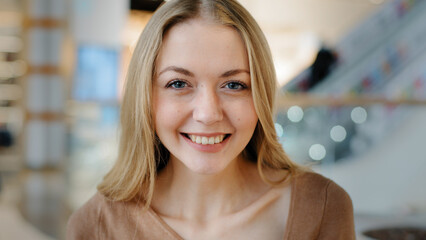 Close-up satisfied woman happy carefree successful cheerful smiling laughing girl blonde 30s woman...