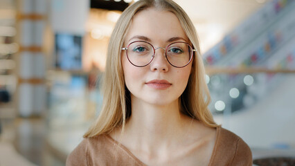 Close up headshot portrait indoors calm Caucasian woman in eyeglasses lady girl blonde female in...