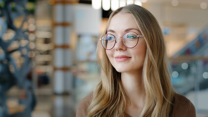 Head shot portrait Caucasian lady female girl in glasses pensive woman looking away ophthalmology services millennial blonde model with healthy eyesight good vision indoors think pondering thinking - obrazy, fototapety, plakaty