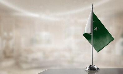 A small Pakistan flag on an abstract blurry background