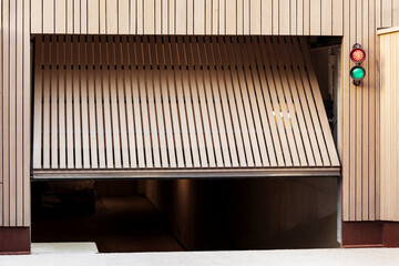 Garage Door to Underground Parking of Residential Apartment Building with Traffic Light. Modern...