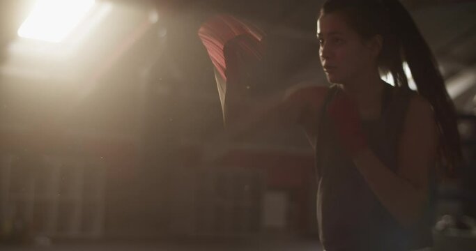 Sportswoman shadow boxing under sunlight